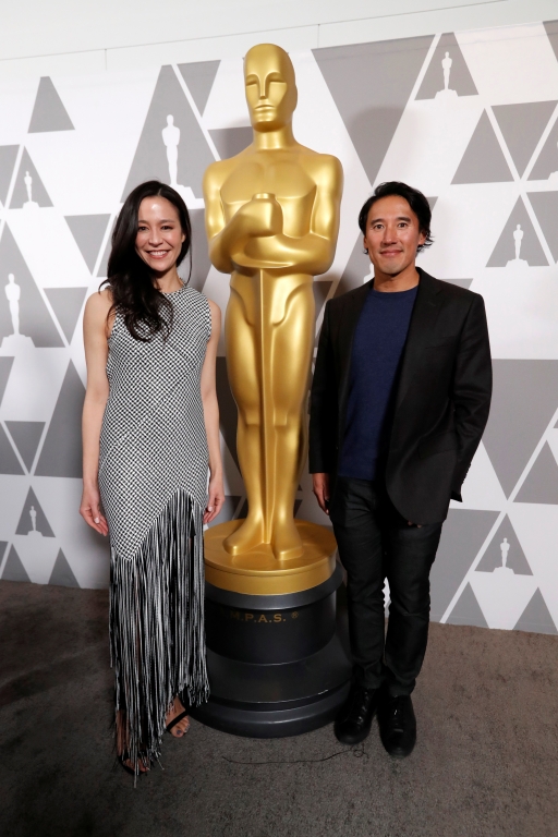 Jimmy Chin and Chai Vasarhelyi Jimmy Chin and Chai Vasarhalyi stand next to a human size Oscar statue