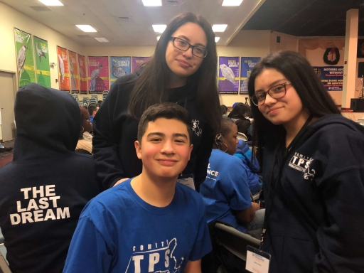 Three Salvadoran American kids Three kids look straight at the camera as they wear dark blue