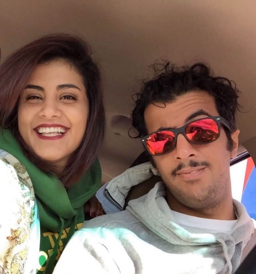 A young woman and a young man smile in a photo