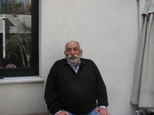 Man with yellowing mustache poses for photo.