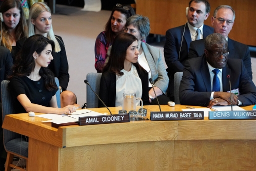 Nadia Murad sits in blue chair next to others listening to testimony.