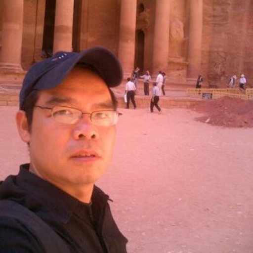 Man taking selfie with old image behind him