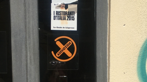 A restaurant displays the Addiopizzo sign on its doors to show it doesn't support the Mafia.