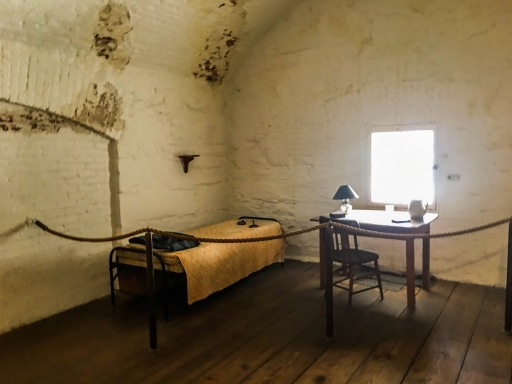 Jefferson Davis' cell A bed and a desk near a window in a cell.