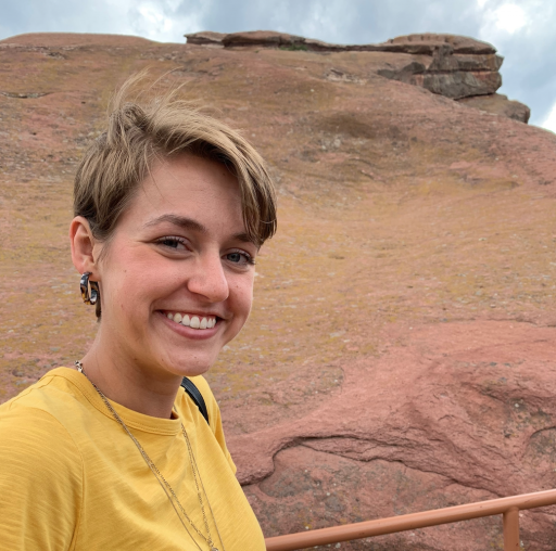 Bianca Hillier wears a yellow shirt and is smiling.