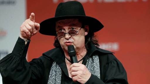 French chef Marc Veyrat speaks after he was awarded with three Michelin stars for his restaurant La Maison des Bois in 2018. He lost his third star in 2019 and is now suing the Michelin Guide for the documentation behind the rating. A man wearing a wide brimmed black hat speaks