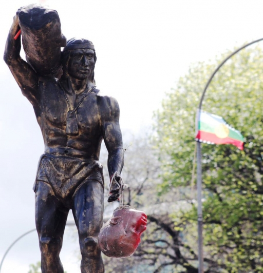 Someone has tied the head of another statue with string to the hand of another statue