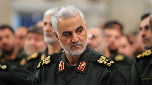 Qassam Soleimani. a man wearing a green military uniform looks to the left.