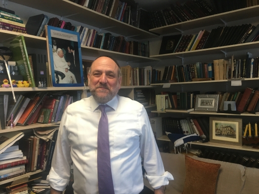 Young people discover they are Jewish all the time, says Poland’s Chief Rabbi Michael Schudrich. Chief rabbi of Poland in his office full of books on shelf.