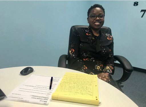 Busayo Fasidi A woman behind a desk with papers