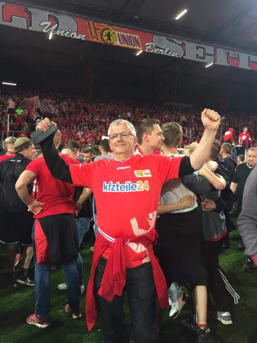 Uwe Dahkle, a Union superfan since the age of 7, wears a red jersey at a game. Uwe Dahkle wears a red jersey at a soccer game.