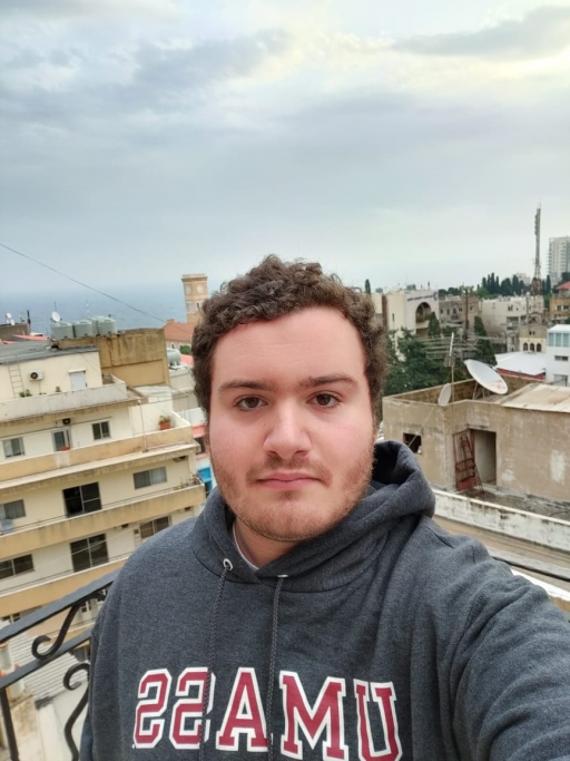 Max Tamer-Mahoney feels safer in Lebanon than the US when it comes to COVID-19. A young man wears a university shirt