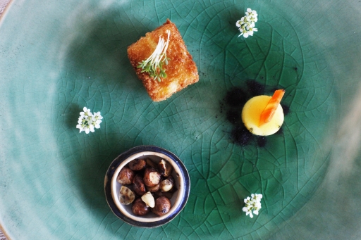 A poetic meal is served on a green plate at Table for One. A poetic meal of three small dishes on a green plate