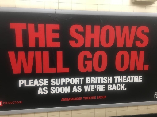 A red sign in a London tube station supports West End theaters. A red sign in a London tube station supports West End theaters.