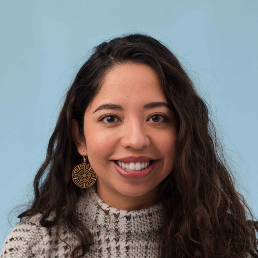 Esmy Jimenez. A woman smiles while posing for a photo.