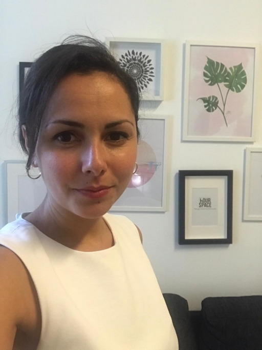 Valentina Dolmova, 32, an organizational psychologist in Sofia, Bulgaria, has chosen to participate in anti-government protests because she doesn't "have a moral alternative." A white woman with brown hair pulled back wears a white blouse in a selfie photo