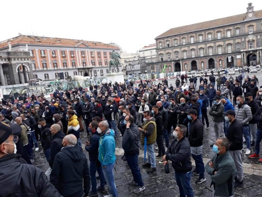 Protesters in Naples gather to speak out against the new coronavirus restrictions. Protesters in Naples gather to speak out against the new coronavirus restrictions.