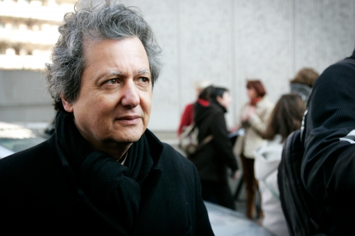 Pierre Haski is a commentator with French public radio France Inter. A white man with silver hair wears a dark coat and stares a bit into the distance.