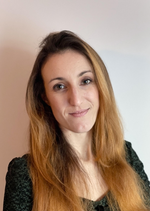 Marta Lorimer, a postdoctoral research associate, at the University of Exeter in Britain, studies the far-right in Europe. A white woman wearing a black top with long brown hair smiles