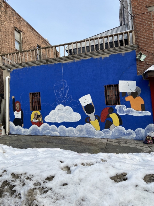 Mural honoring the life of prisoner of conscience Moustafa Kassem in Queens, New York, commissioned by the Freedom Initiative and painted by Brandi Jones of Black Village Arts. A photo of an unfinished mural in a snowy lot.
