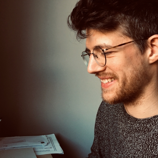 Activist Joachim Debelder works with Migrations Libres, a support group for undocumented migrants and refugees. A man wears glasses and smiles