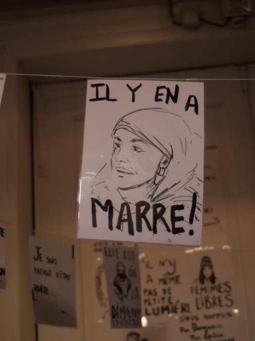 A protest sign reads "Il y'en a marre" or "We've had enough of it." A protest sign reads "Il y'en a marre," or "We've had enough of it."