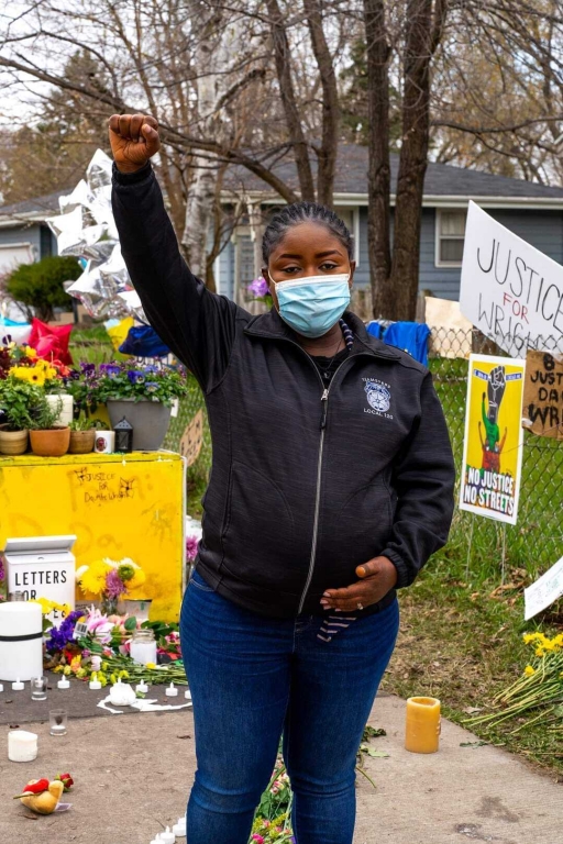 Alfreda Daniels Juasemai, a community organizer, holds a fist up in the air. Alfreda Daniels Juasemai, a community organizer, holds a fist up in the air.