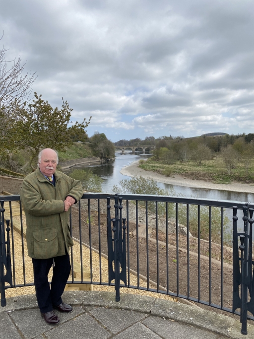 John Greenwell is Coldstone's Conservative Party councilor and a supporter of Scotland staying within the UK. John Greenwell wears a green jacket, black pants and stands near a black fence overlooking a winding river.