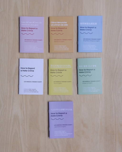 Booklets on "How to Report a Hate Crime" Colorful booklets on a wooden table on "How to Report a Hate Crime"