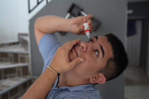 Camilo Suarez places droplets in his right eye to reduce inflammation. Suarez was hit with a rubber bullet during a vigil on May 2, and lost most of his sight in that eye. Camilo Suarez places droplets in his right eye to reduce inflammation. Suarez was hit with a rubber bullet during a vigil on May 2, and lost most of his sight in that eye.