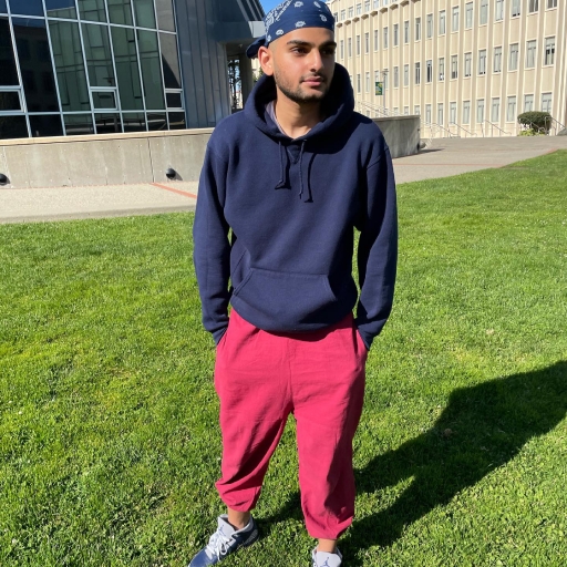 Abdullah Jamalallail is a college student in San Francisco. Abdullah Jamalallail wears pink sweats and a blue hoodie as a college student in San Francisco.