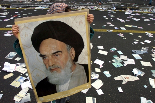 An Iranian girl carries a photo of the late leader of the Islamic revolution, Imam Khomeini, as she walks on a street covered with pre-election leaflets near Azadi Square in Tehran February 11, 2000. An Iranian girl carries a photo of the late leader of the Islamic revolution, Imam Khomeini, as she walks on a street covered with pre-election leaflets near Azadi Square in Tehran February 11, 2000.