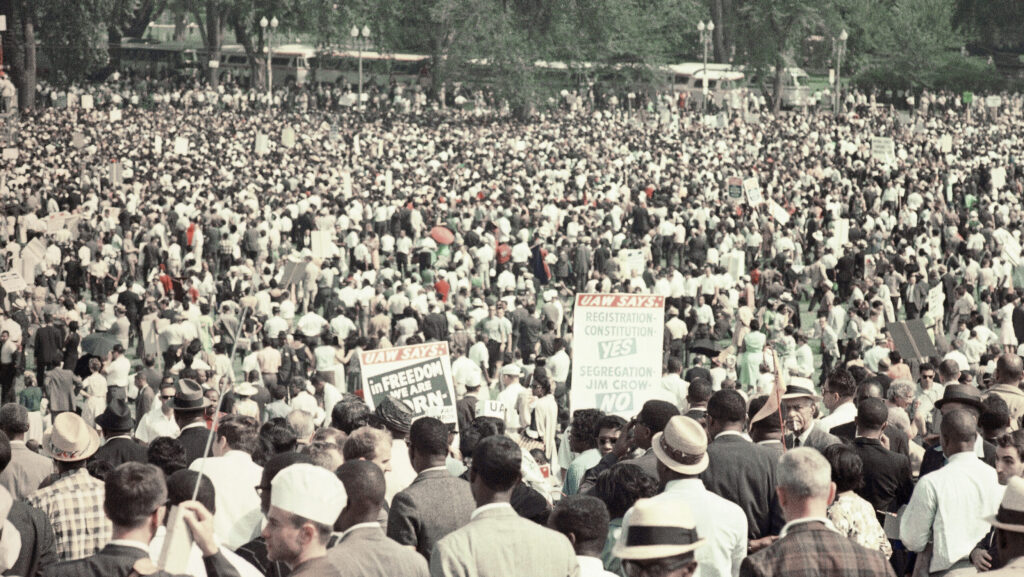 Large crowd at the 1963 March on Washington, with UAW signs reading "In Freedom We Are Born" and "Segregation Jim Crow No
